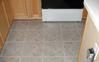 Finished installation of floor tiles in kitchen.